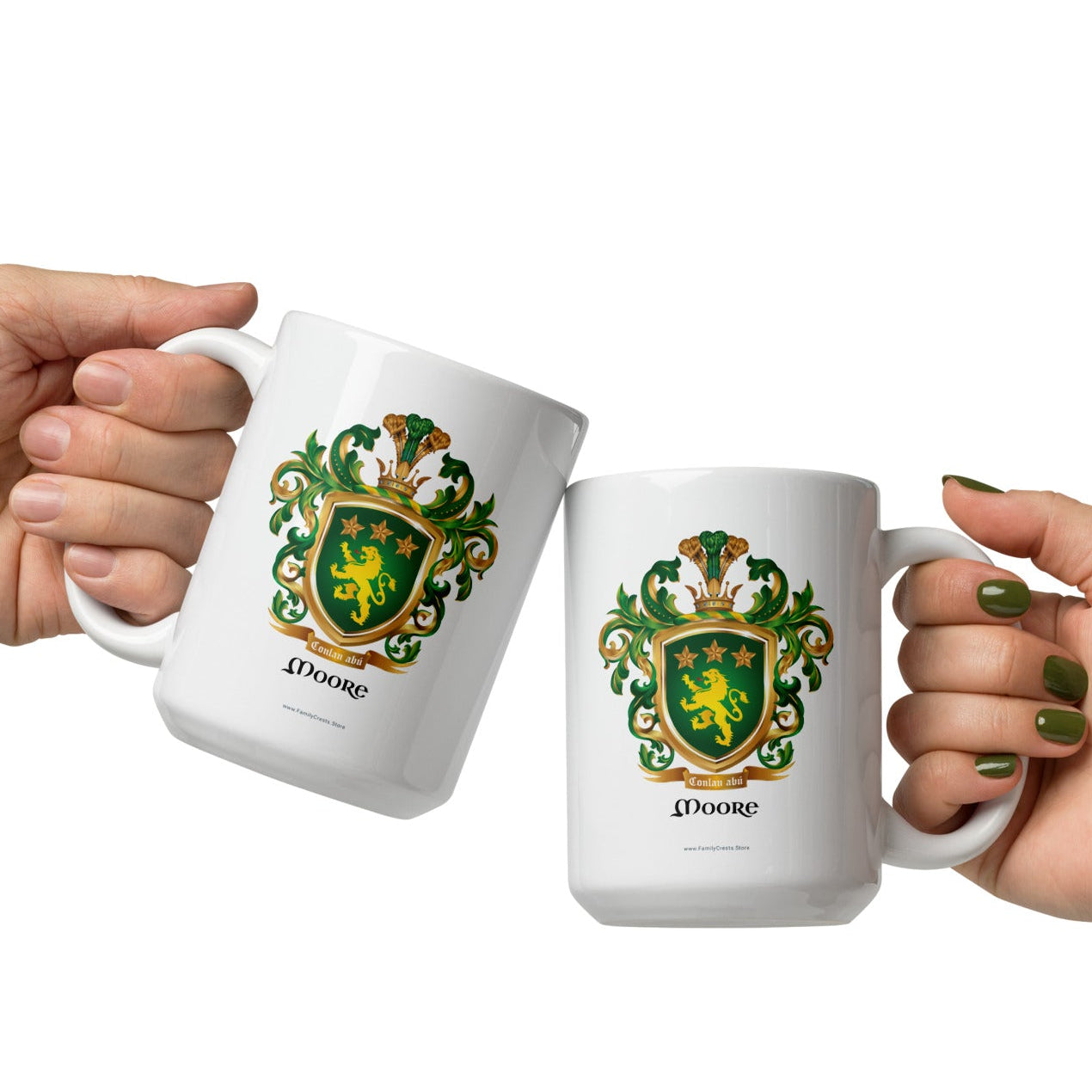 Two hands holding white Moore family crest mugs with the mugs touching in a cheers gesture pictured on a white background