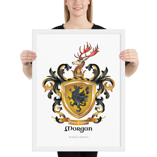 A woman standing in a white background, holding a white framed print of the Morgan Family Coat of Arms featuring a black griffin on a gold shield with a stag on the crest.