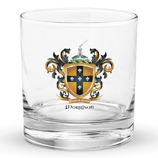 A clear classic heavy base rocks glass on a white background, printed with the Morrison Family Crest featuring a blqck cross with 5 fleur de lis on a gold shield.