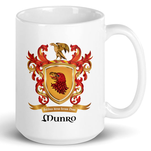 A white ceramic mug featuring a printed Munro family crest with a red and gold eagle, ornate red flourishes, and the name 'Munro' in black script below.