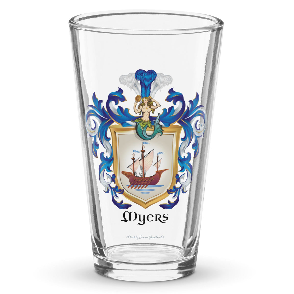 A clear classic pint beer glass on a white background, printed with the Myers Family Coat of Arms featuring a wooden galley ship on a white shield with a mermaid at the crest of the shield.