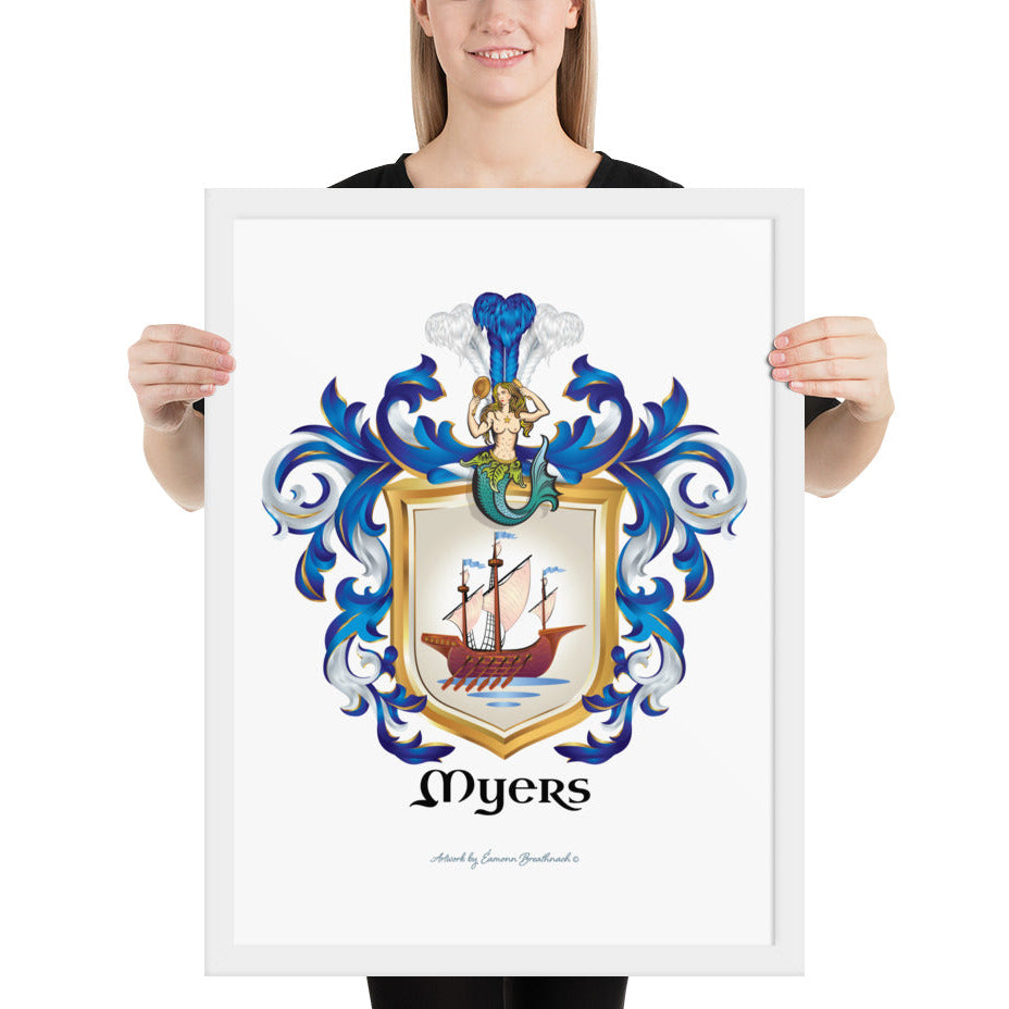 A woman standing in a white background, holding a white framed print of the Myers Family Coat of Arms featuring a wooden galley ship on a white shield with a mermaid at the crest of the shield.