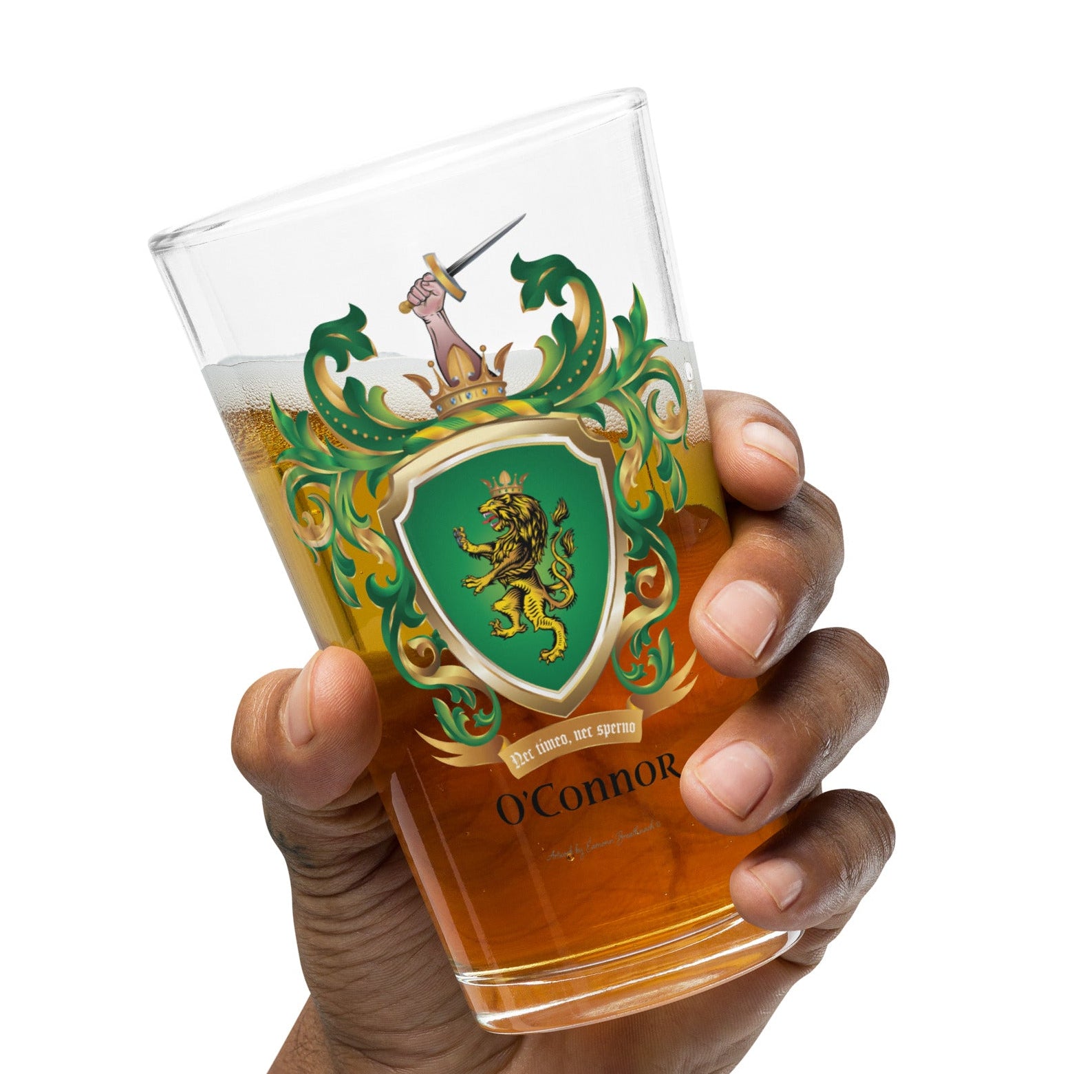 A hand holding a pint glass of beer with O'Connor-family-crest with a lion on a green shield on the front