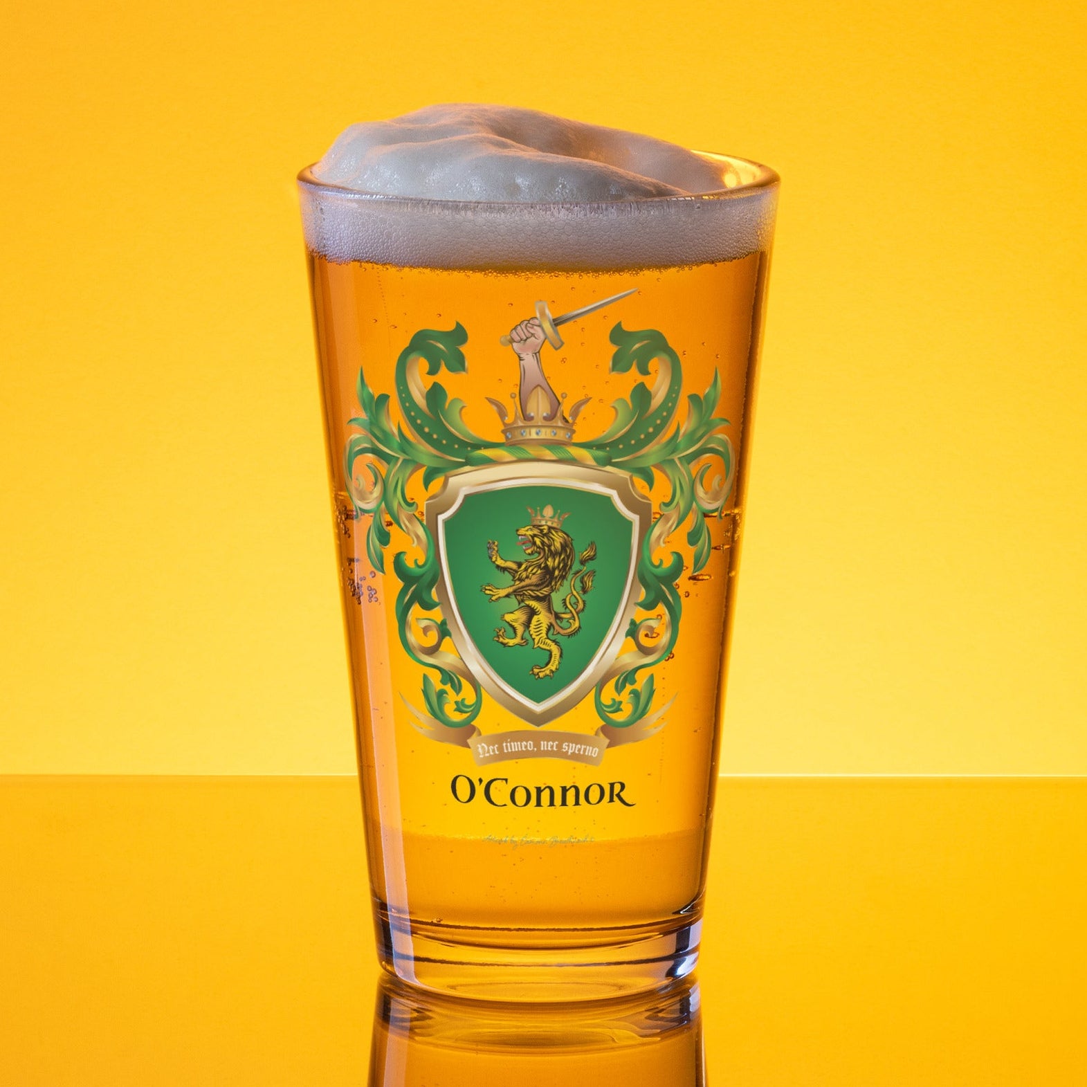A beer glass, full of larger with O'Connor-family-crest with a lion on a green shield on the front
