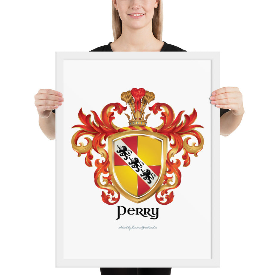A woman standing in a white background, holding a white framed print of the Perry Family Crest which features a shield quartered with red and yellow/gold sections and a white diagonal band with 3 black lions.