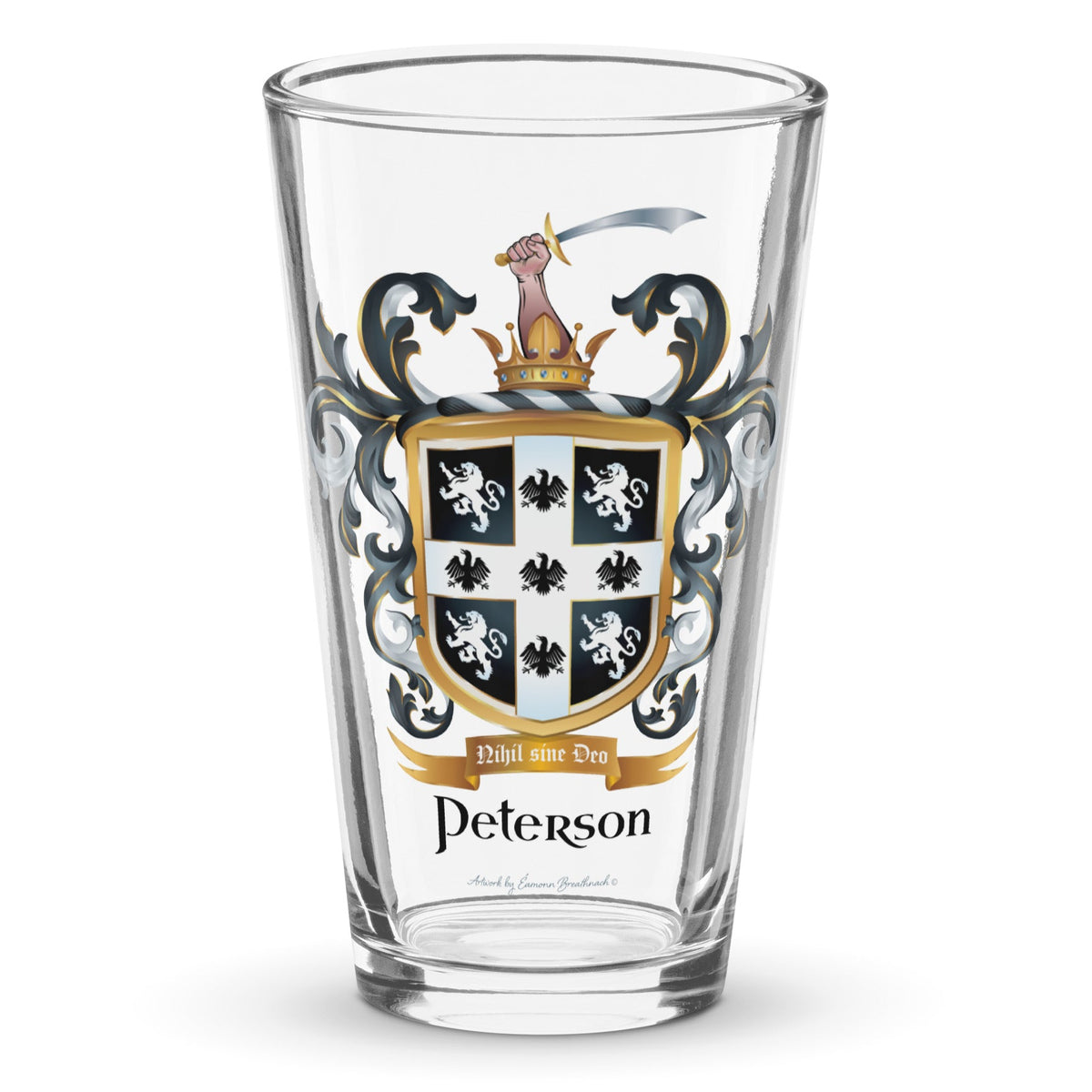 A clear classic pint beer glass on a white background, printed with the Peterson Family Crest featuring 4 lions and 5 eagles on a black shield.