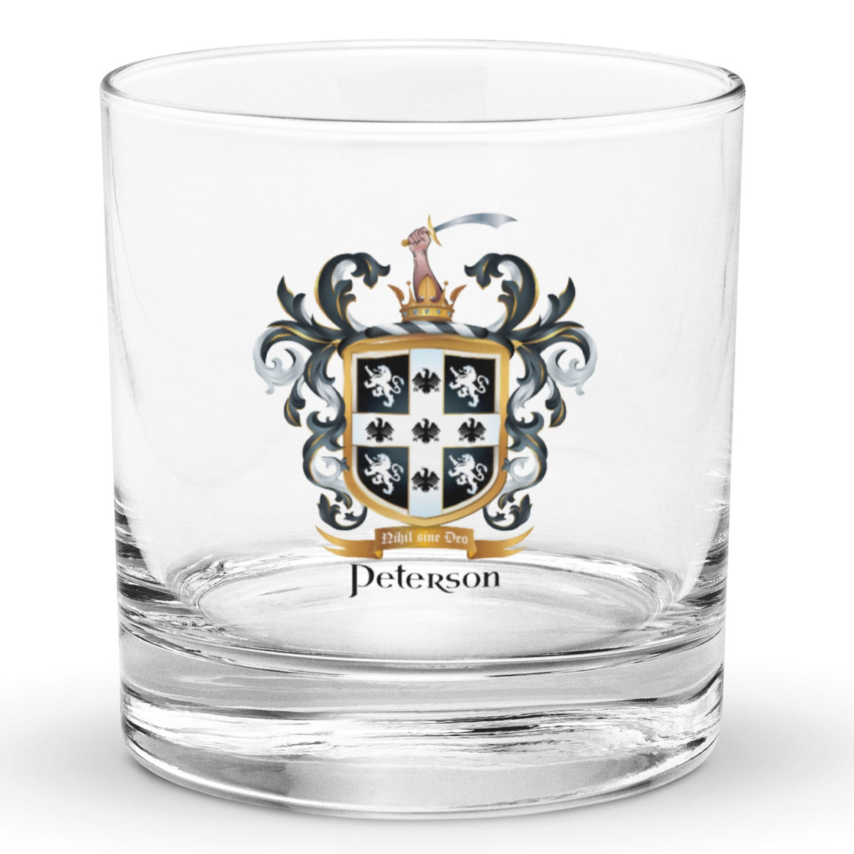 A clear classic heavy base rocks glass on a white background, printed with the Peterson Family Crest featuring 4 lions and 5 eagles on a black shield.