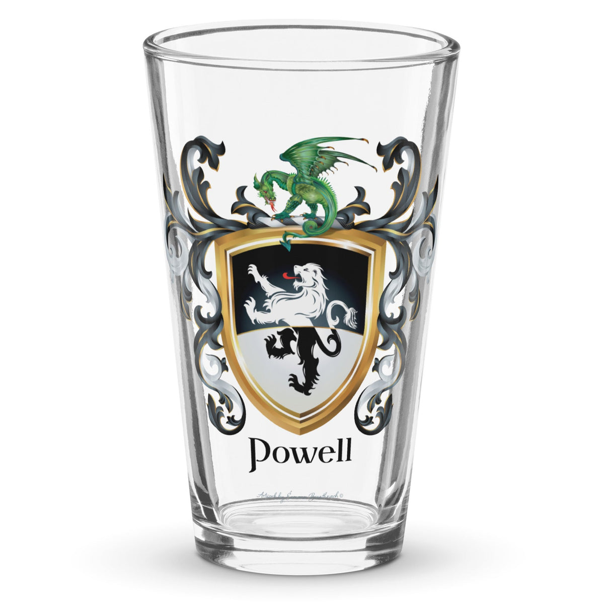 A clear classic pint beer glass on a white background, printed with the Powell Family Coat featuring a black and white shield split with black in the top half, white in the bottom, with a standing lion that also has a white-black color split, and above the lion is a dragon sitting on the crest, and the shield is surrounded with black and white mantling, with the name Powell beneath it in elegant heraldic lettering.