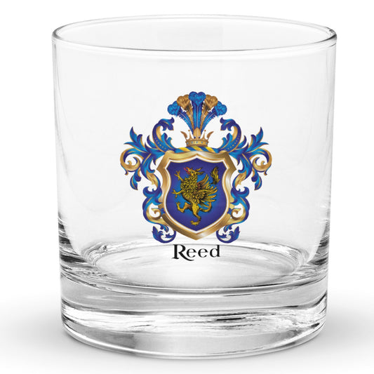 A clear classic heavy base rocks glass on a white background, printed with the Reed Coat of Arms featuring a blue shield with a gold griffin.