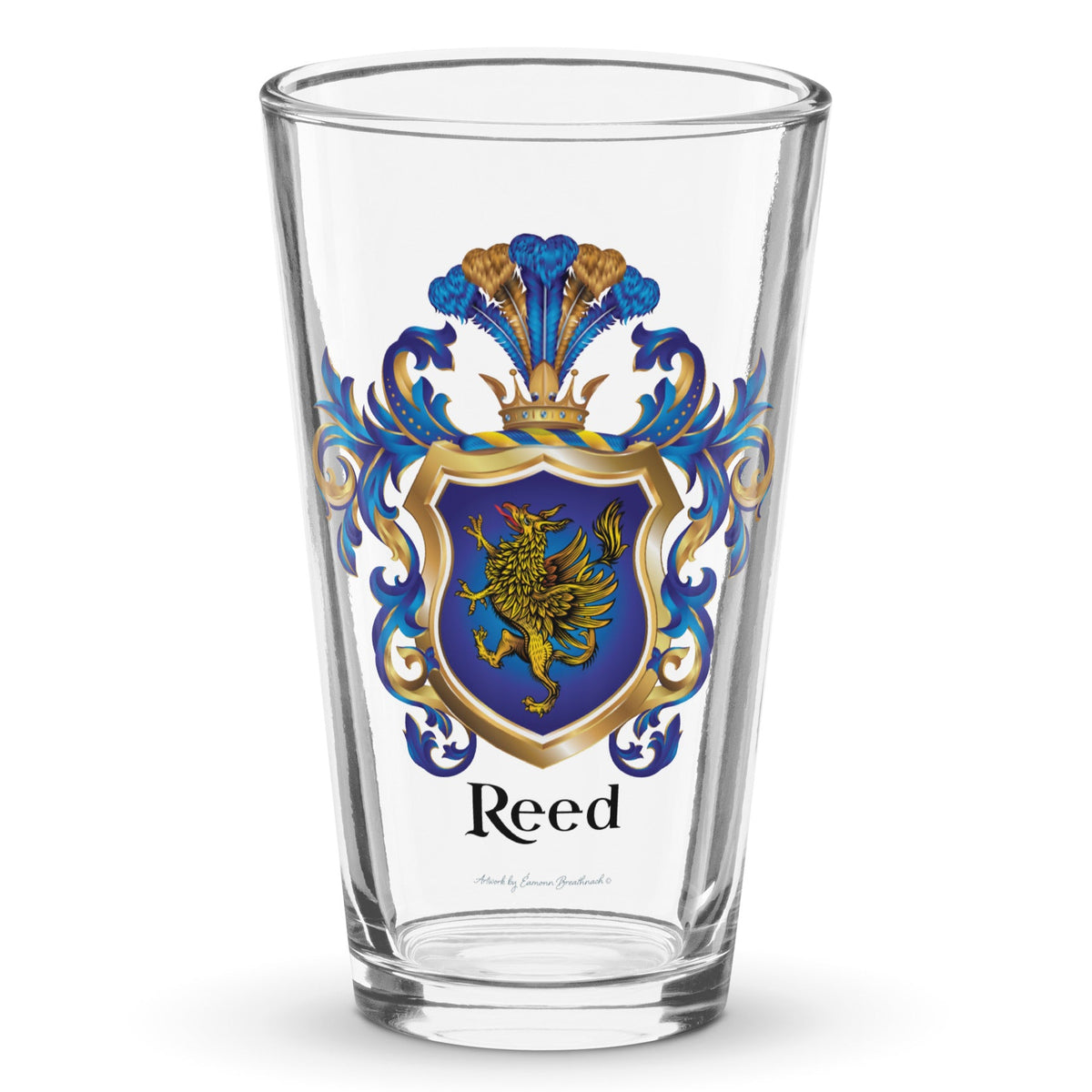 A clear classic pint beer glass on a white background, printed with the Reed Family Crest which has a blue shield with a gold griffin.