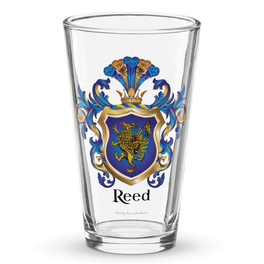 A clear classic pint beer glass on a white background, printed with the Reed Family Crest which has a blue shield with a gold griffin.