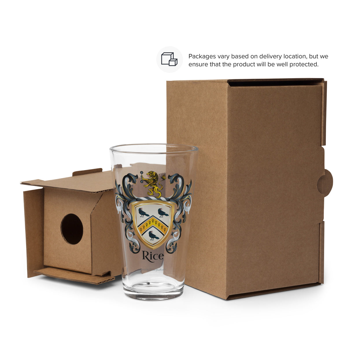 A clear drinking glass with a printed crest and the word 'Rice' stands in front of a brown cardboard box, with a smaller open cardboard insert beside it on a white background. A small note at the top says packaging varies based on delivery location.