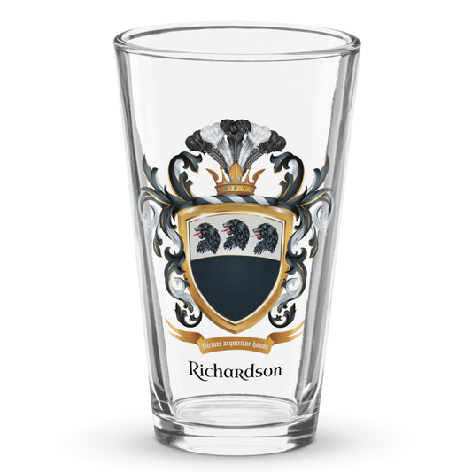 A clear classic pint beer glass on a white background, printed with the Richardson Family Crest featuring 3 lion heads on a split black and white shield.