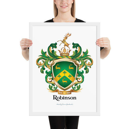 A framed print of the Robinson-Family-Crest on white paper featuring a green shield with three gold stags, a golden chevron with 3 shamrocks and above the shield a stag standing on a gold crown and below the shield a motto and the name Robinson in black letters.