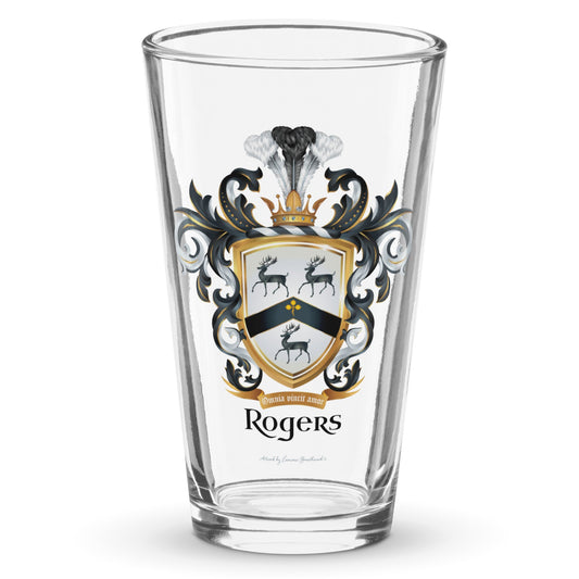 A clear classic pint beer glass on a white background, printed with the Rogers Family Crest which features 3 black stags and a black chevron on a white shield.