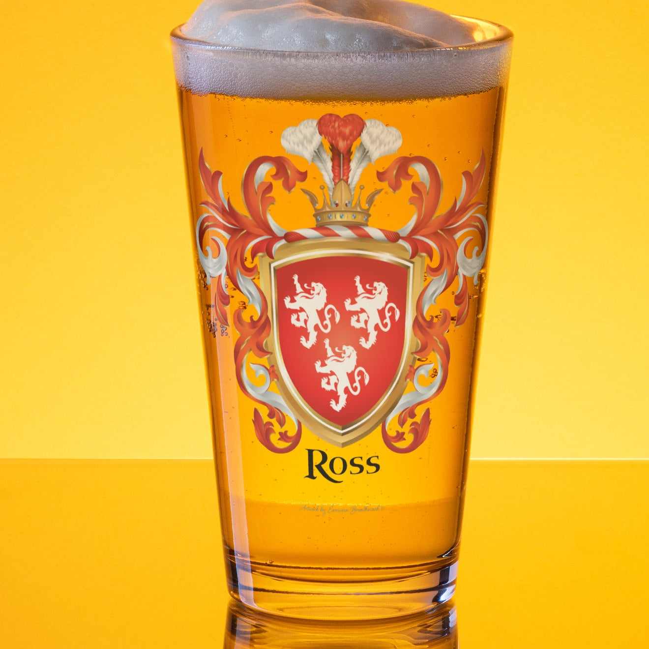 Beer glass with a Ross crest design on a yellow background