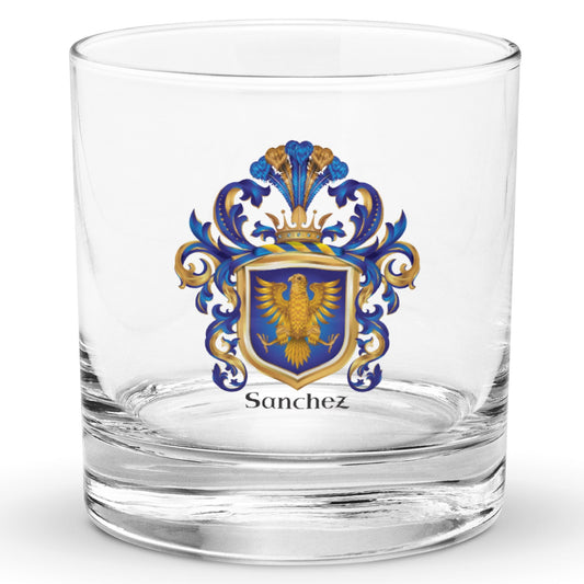 A classic heavy base rocks glass with a Sanchez Family Crest featuring a golden eagle on a blue shield