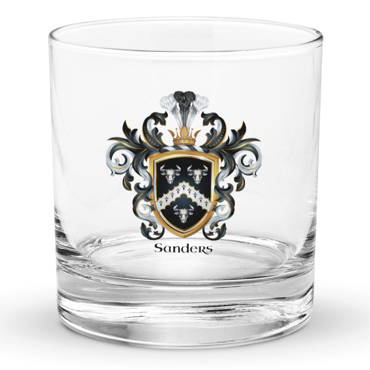 A clear classic heavy base rocks glass on a white background, printed with the Sanders Family Crest featuring 3 white bull heads and a chevron on a black shield.