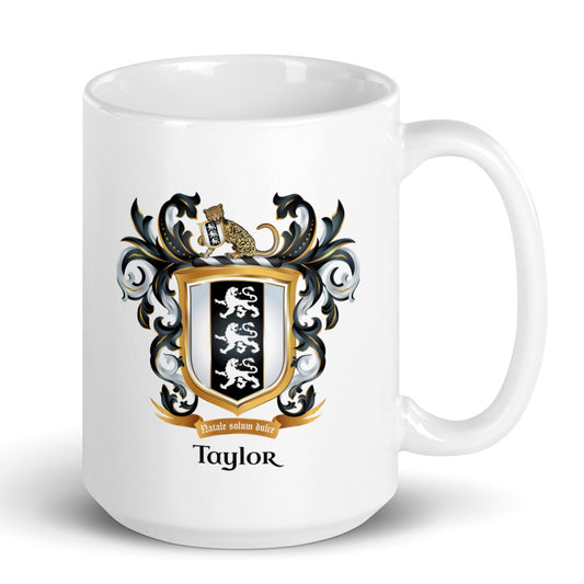 A white mug with the Taylor Family Crest (with the name 'Taylor' in black text below the shield that has 3 white lions on a black and white shield) on a white background