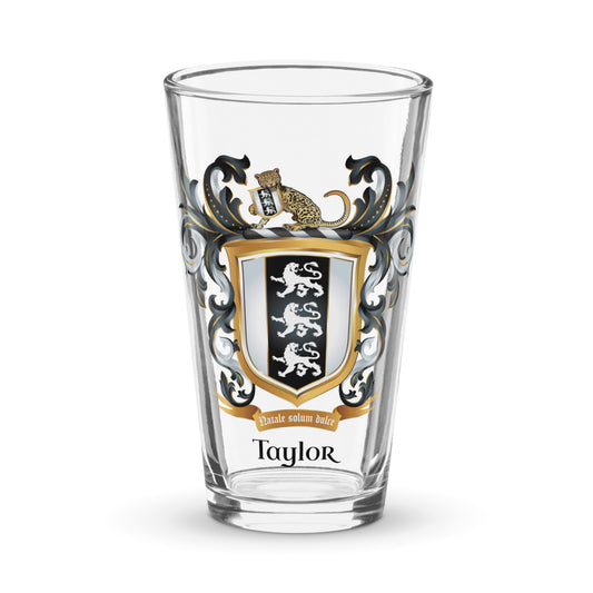 Clear pint glass with Taylor family crest and the name 'Taylor' in black text below the shield that has 3 white lions on a black and white shield on a white background 