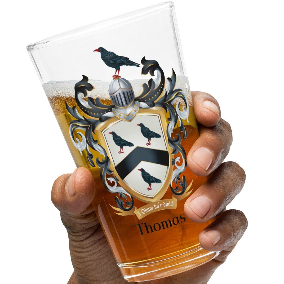 Hand holding a glass with a Thomas Family Crest design and the name 'Thomas' on a white background