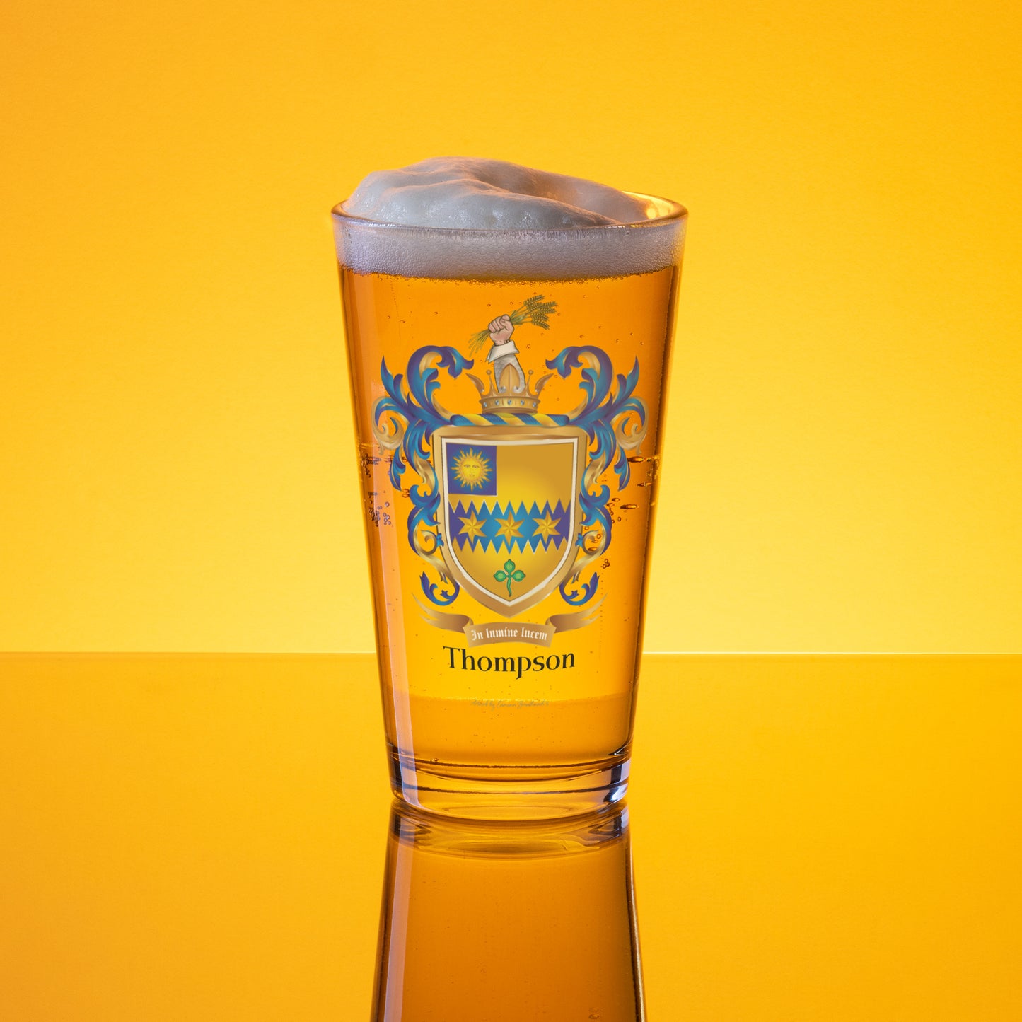 Thompson Family Crest Glass of beer with a crest design on a yellow background