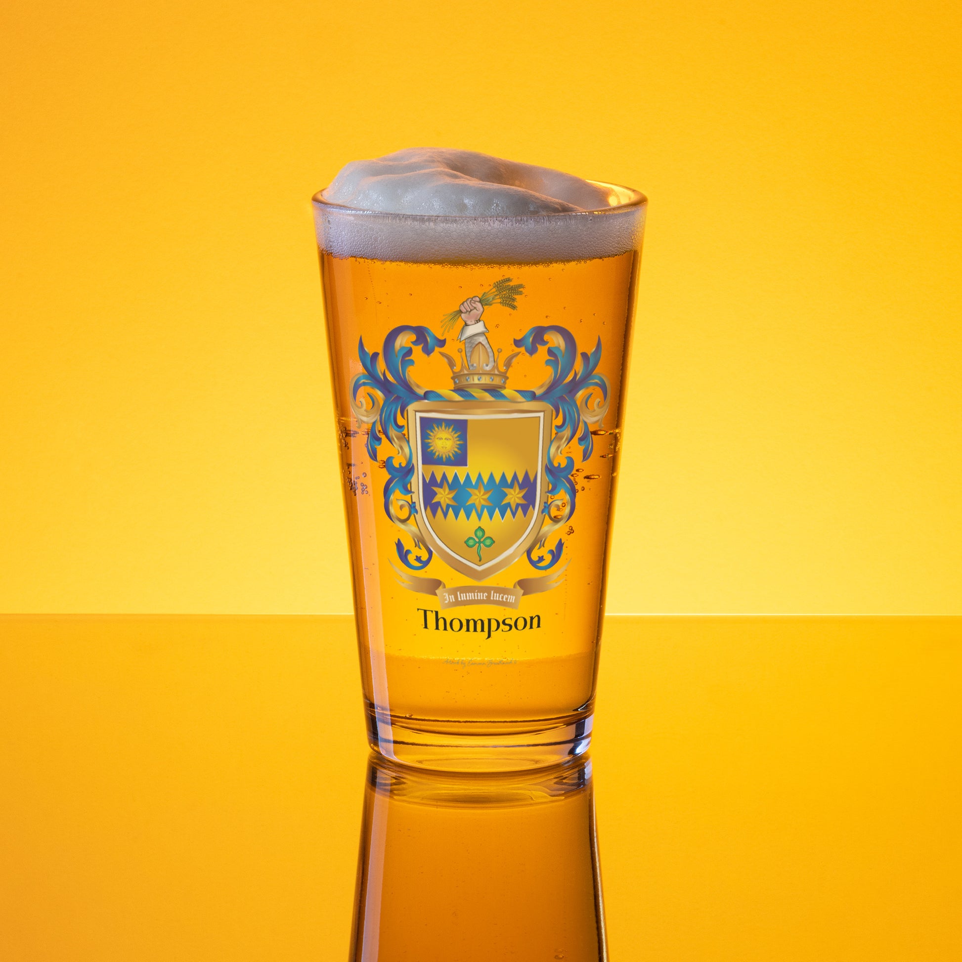 Thompson Family Crest Glass of beer with a crest design on a yellow background