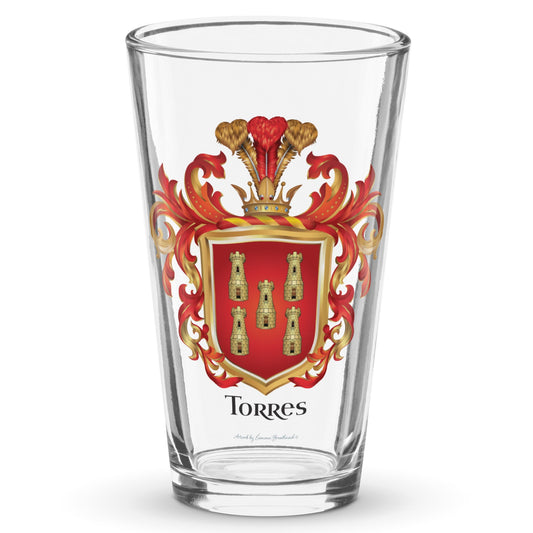 A class clear pint beer glass with a on a white background with the Torres Family Crest featuring 5 gold towers on a red shield printed on it.