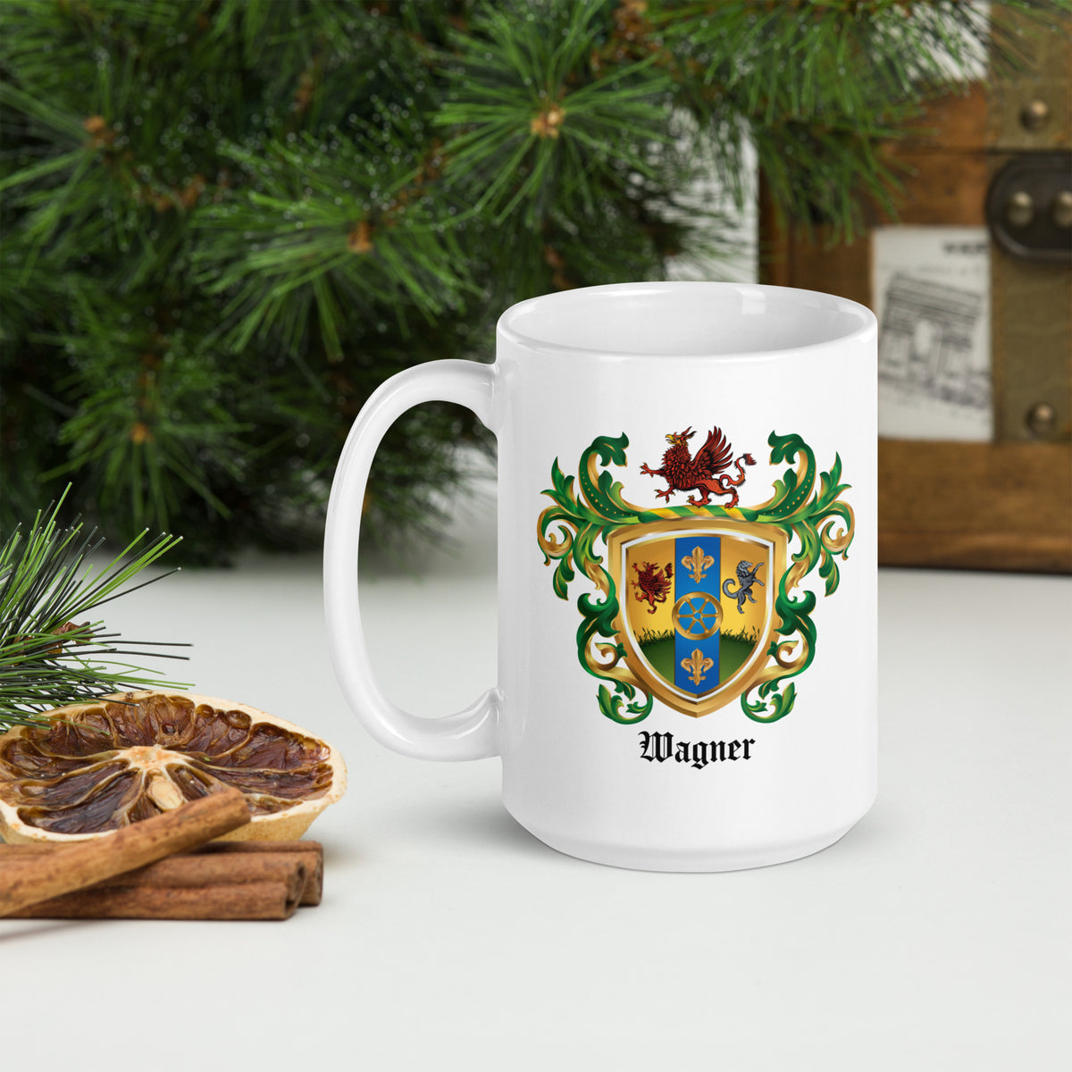 Wagner Family Crest mug featuring cartwheel and emblems on a white table with christmas tree in background