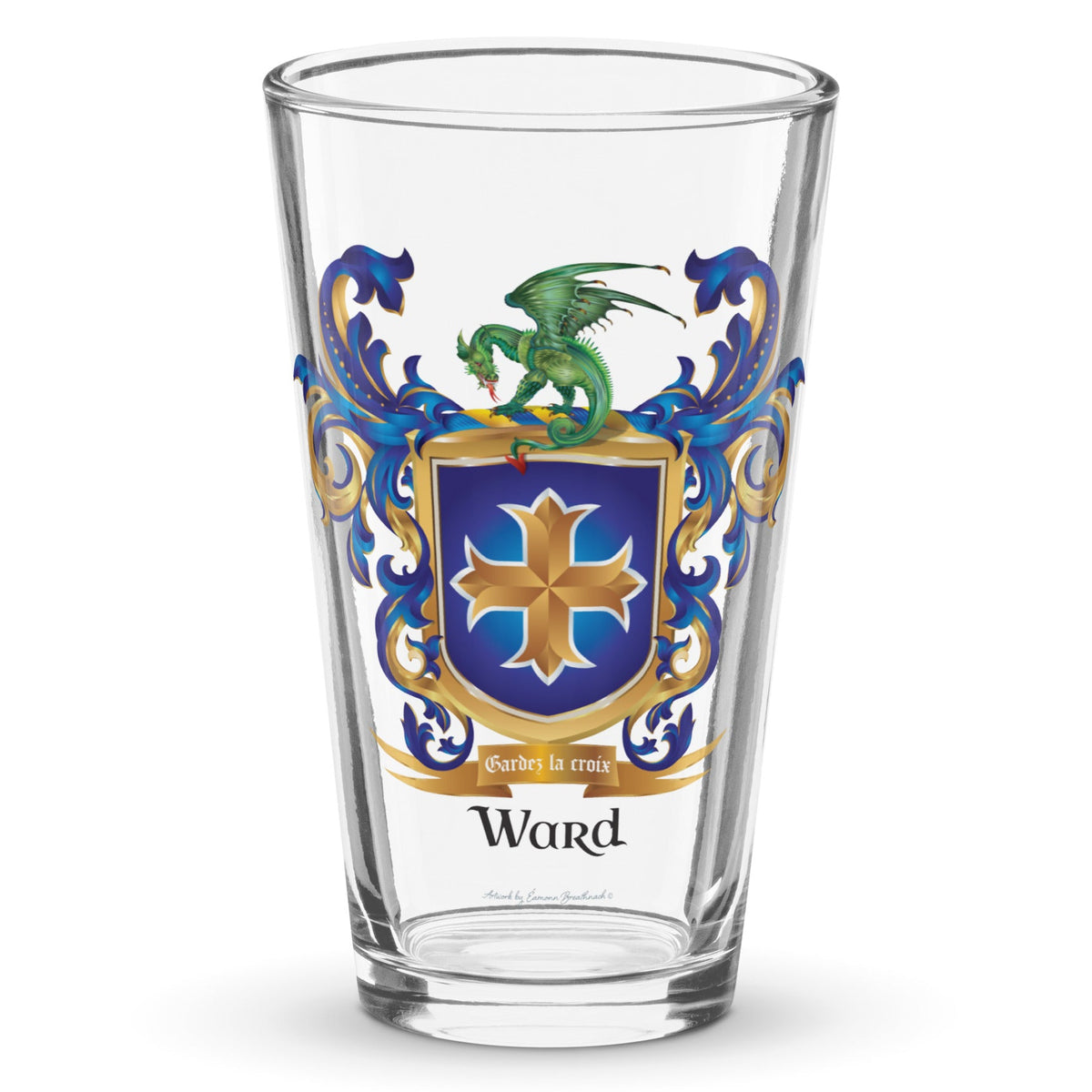 A clear classic pint beer glass on a white background, printed with the Ward Family Crest featuring a bue shield with a gold creoo and a dragon on the crest.