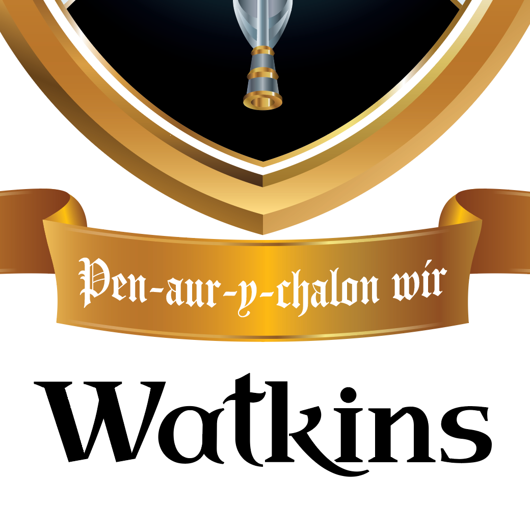 A closeup of the Watkins Family Crest featuring a gold rimmed black shield and a gold motto ribbon with white gothic text reading 'Pen-aur-p-chalon wir', and the word 'Watkins' in large black text below on a white background.