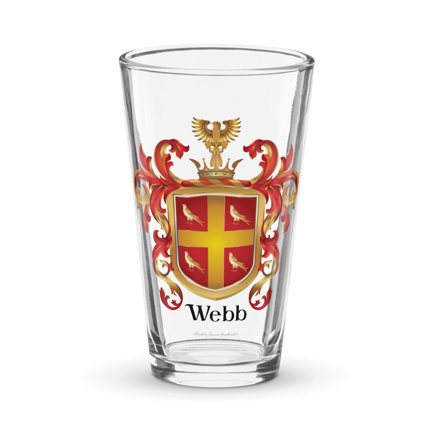 Pint glass with the Webb Family Crest on the front of it pictured on a white background. TYhe crest has 4 birds and a gold cross on a red shield