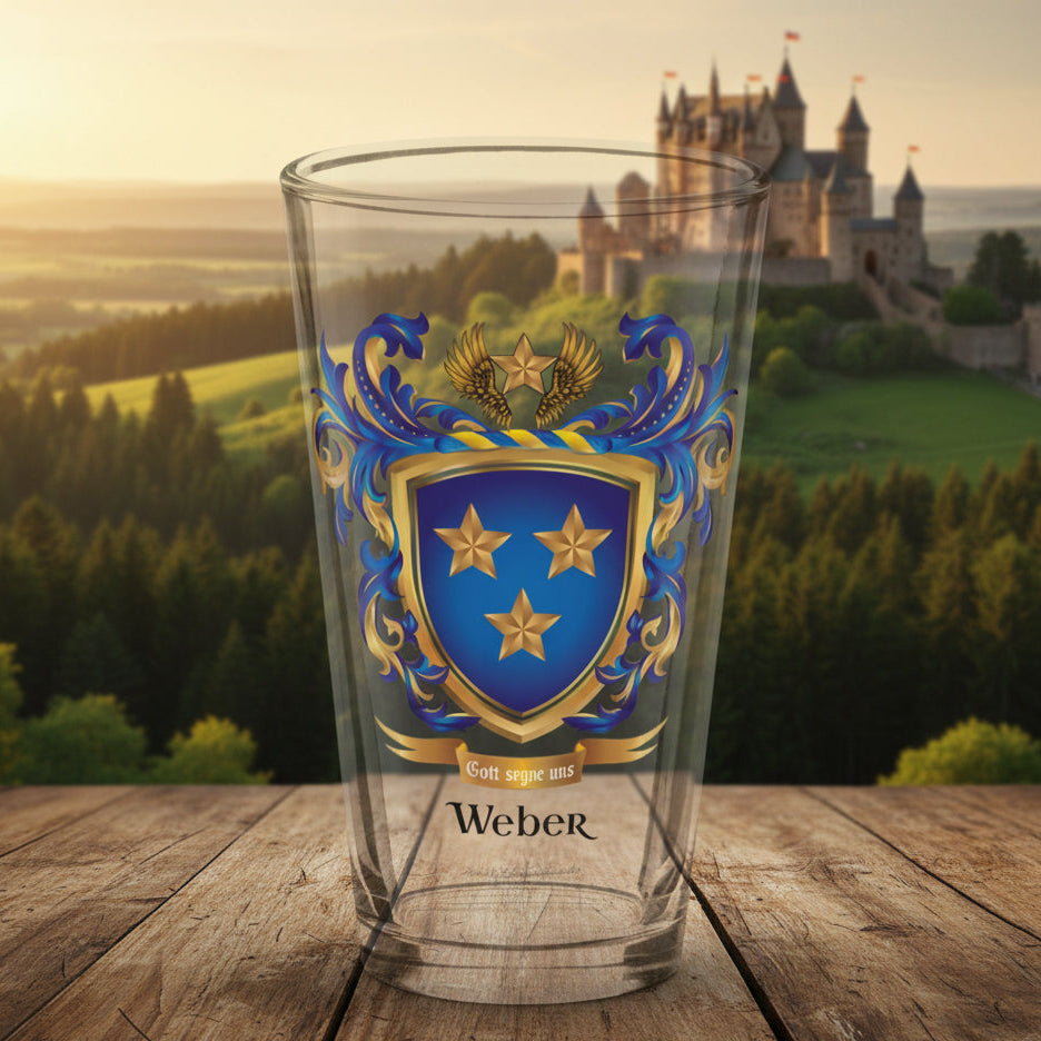 A clear pint glass featuring a custom printed Weber family crest with a blue shield, gold stars, and a gold eagle, on a white background.
