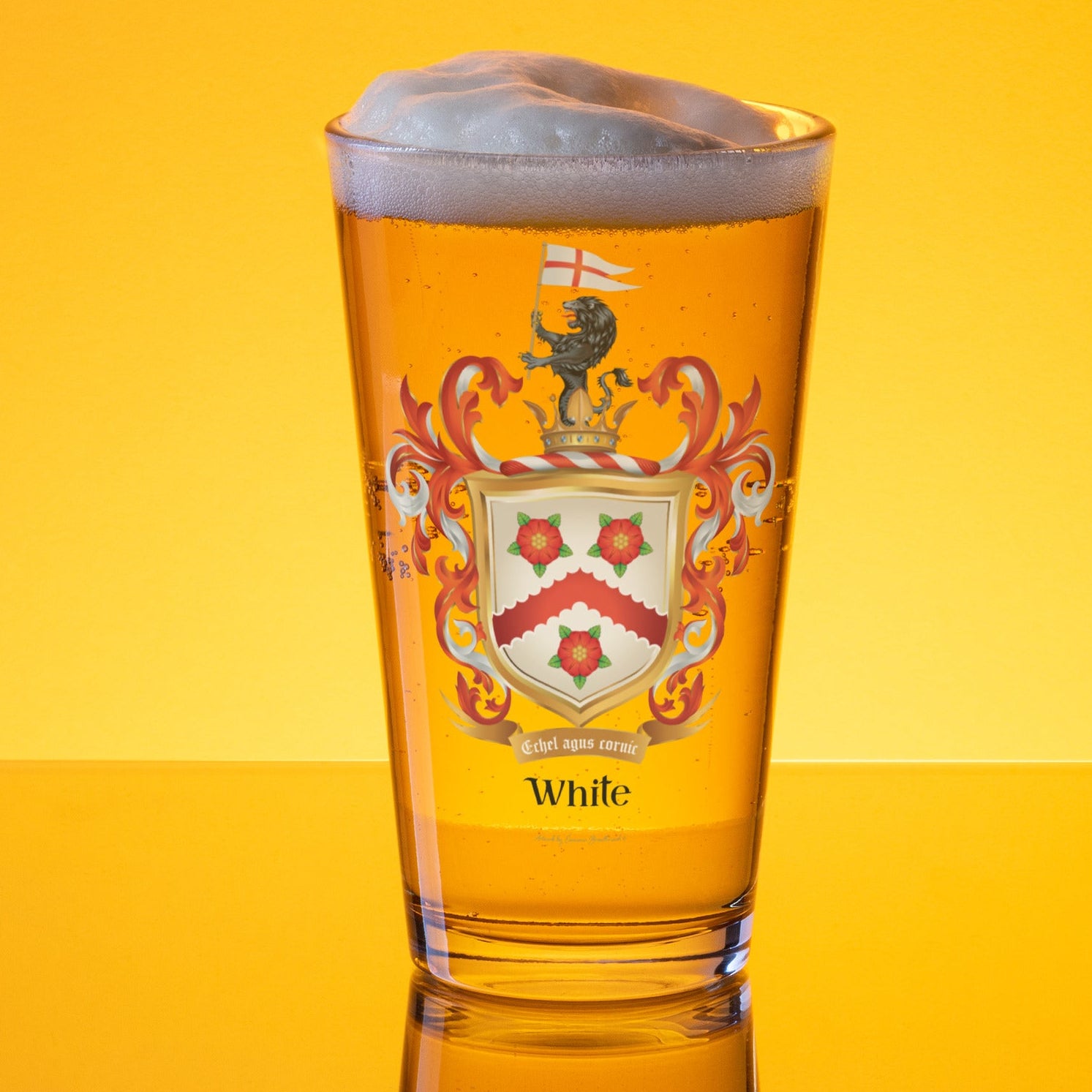 A clear pint glass filled with golden beer and topped with white foam, featuring a hite Family Crest with the name 'White' below it, set against a bright yellow gradient background.