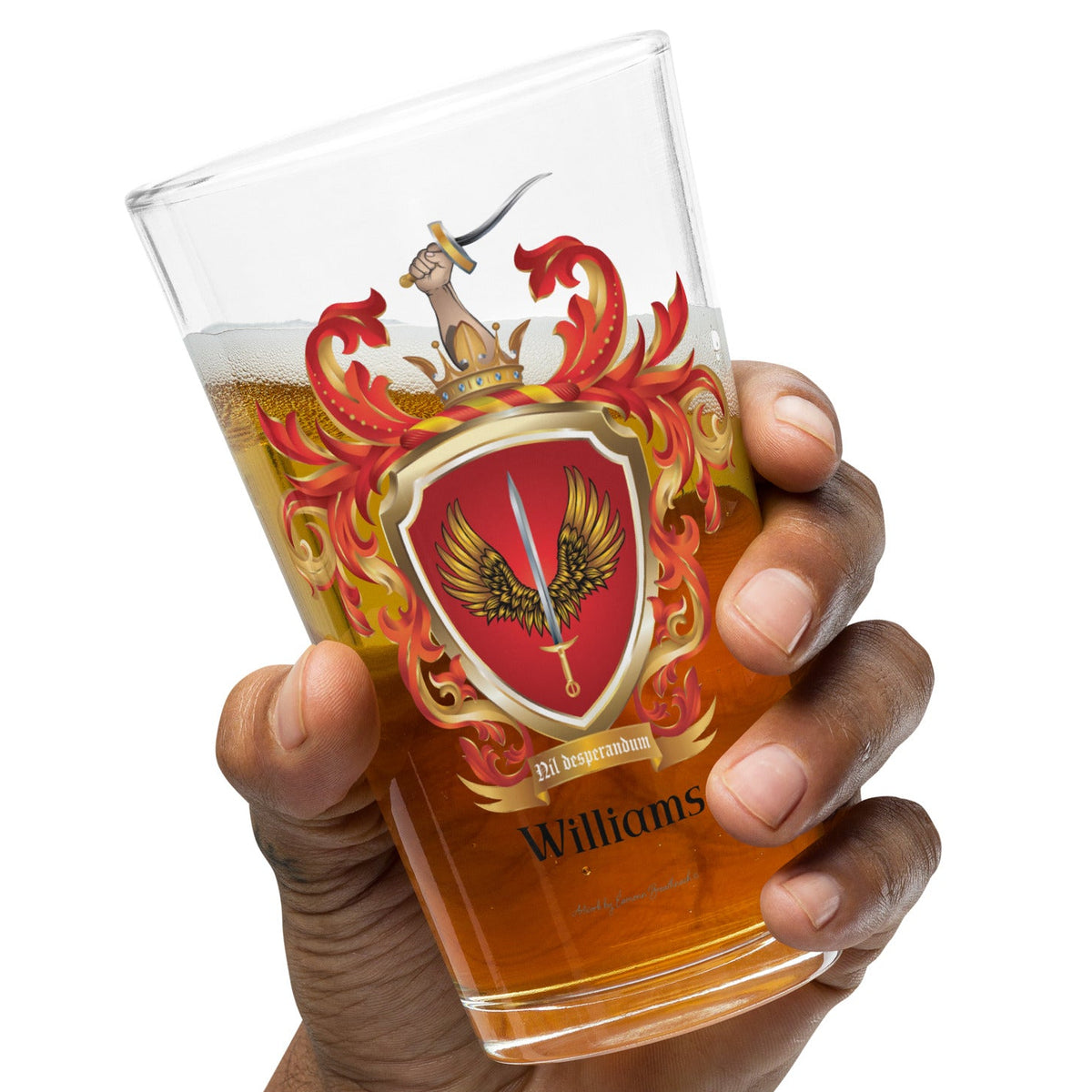 Hand holding a Williams family Crest pint beer on a white background