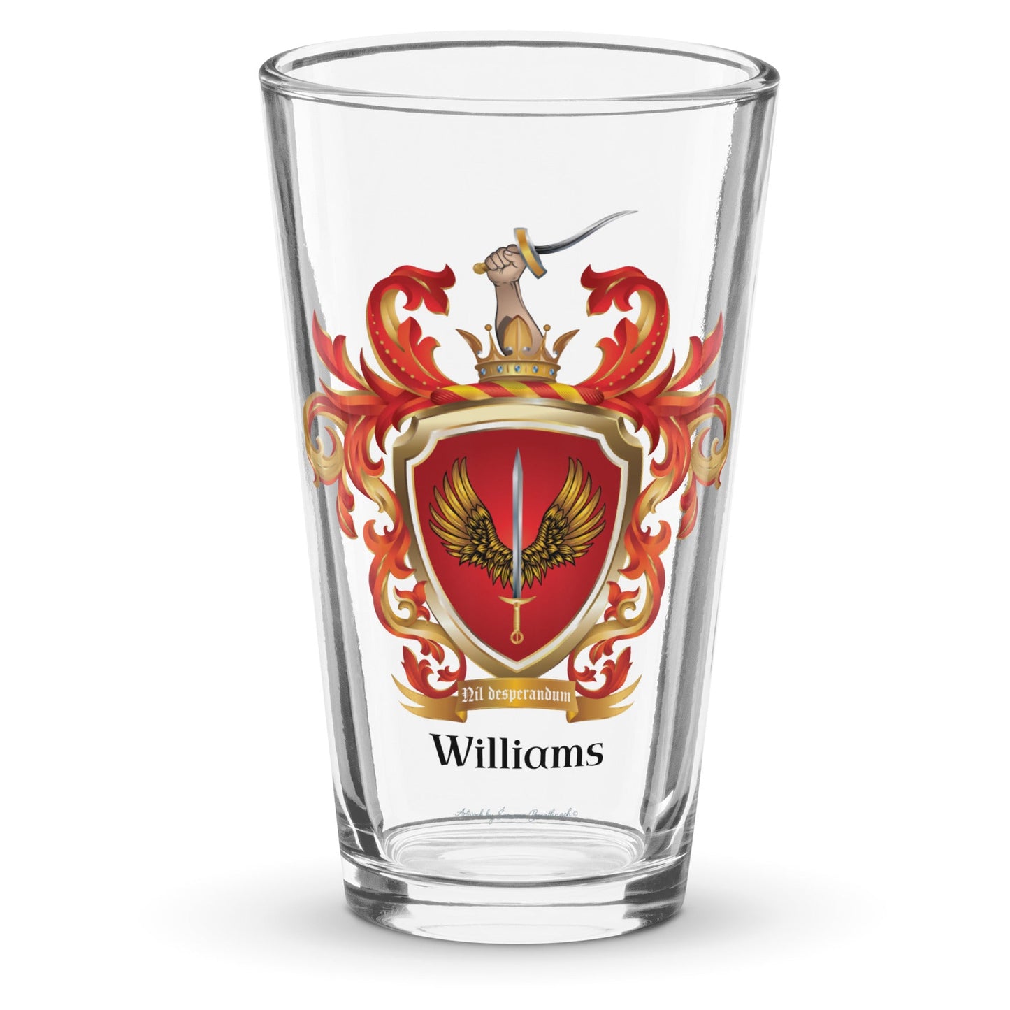 Williams Family Crest pint glass against a a white background with the coat of arms on the glass showing a sword between two golden wings on a red shield and a hand with a sword coming out of a crown at the top on the crest 