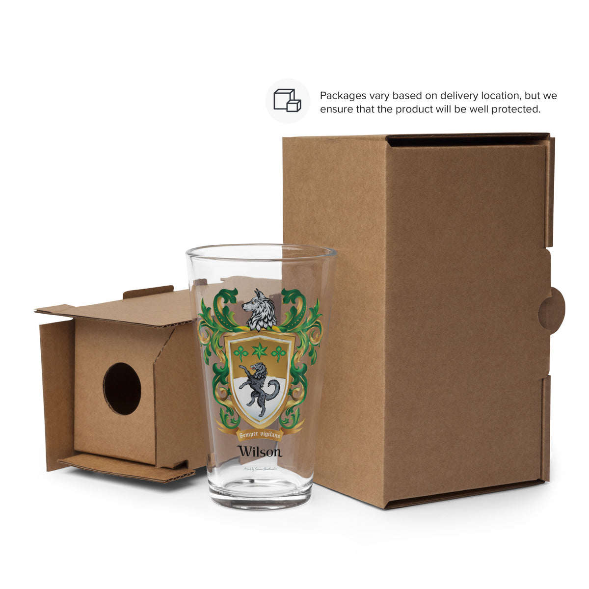 Glass with decorative family crest and 'Wilson' coat of arms in front of a cardboard box