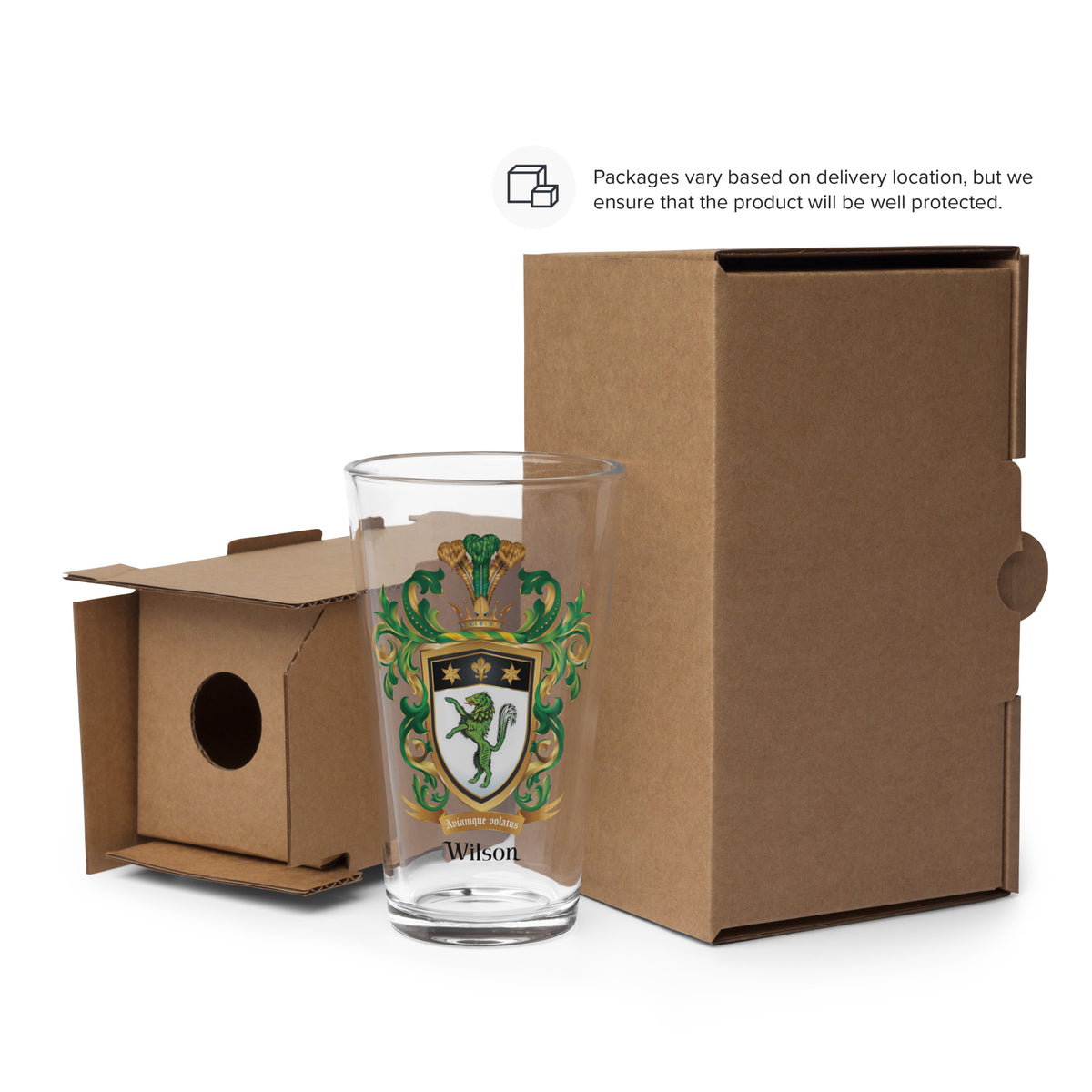 Glass with a Wilson Family Crest in front of an open cardboard box.