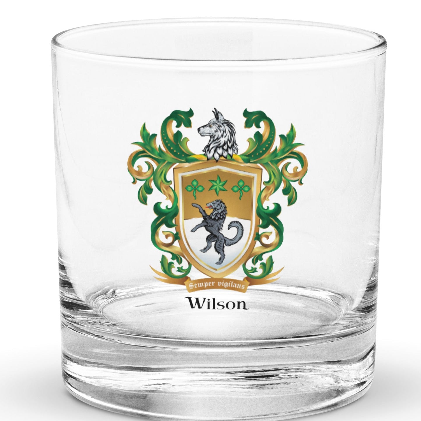 A clear rocks glass with the Wilson Family Crest featuring a black wolf