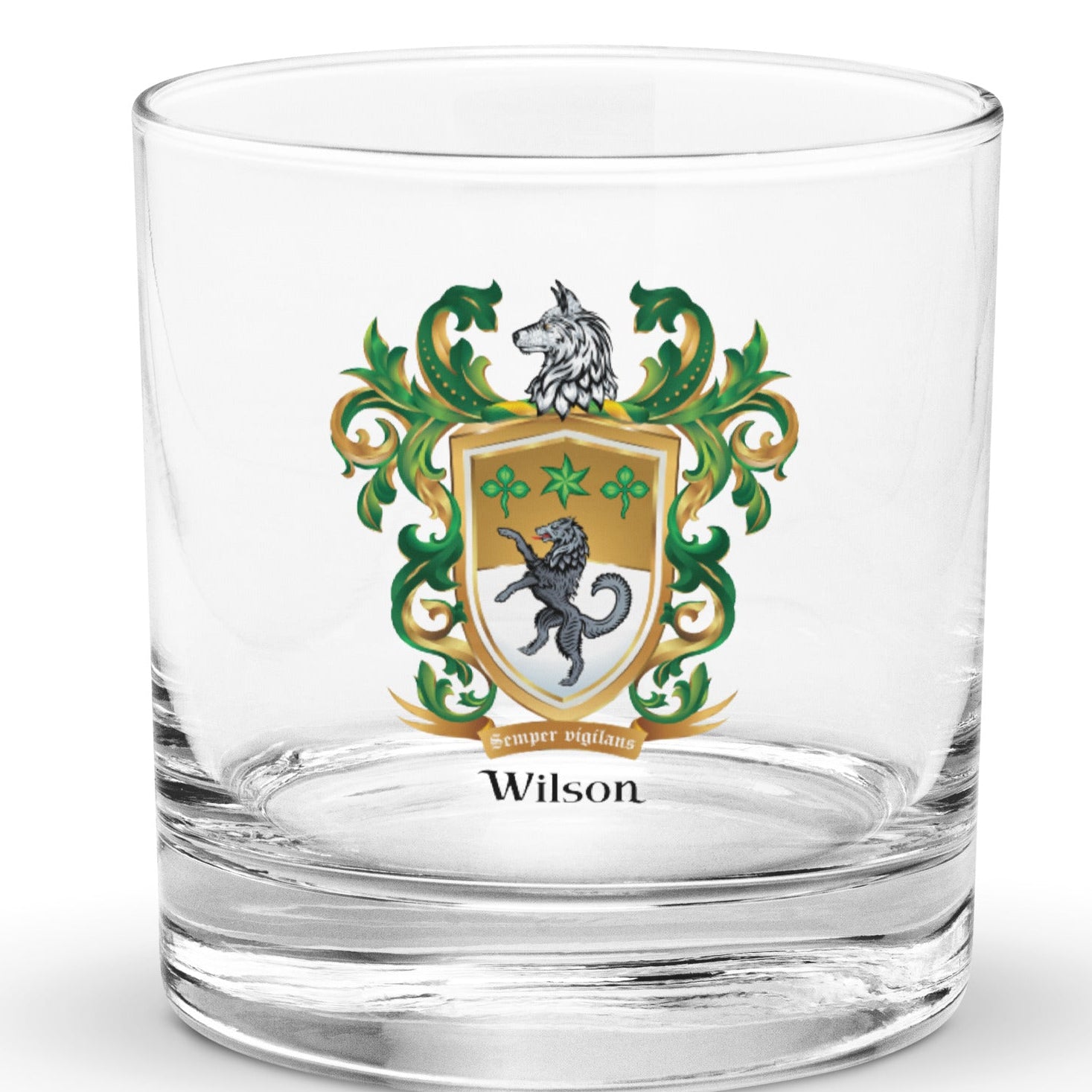 A clear rocks glass with the Wilson Family Crest featuring a black wolf
