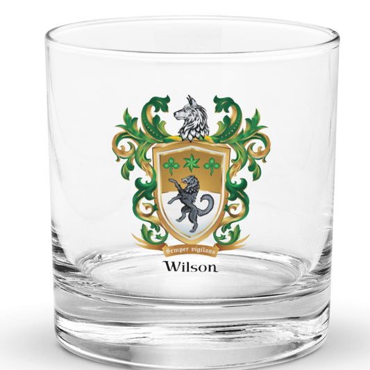 A clear rocks glass with the Wilson Family Crest featuring a black wolf