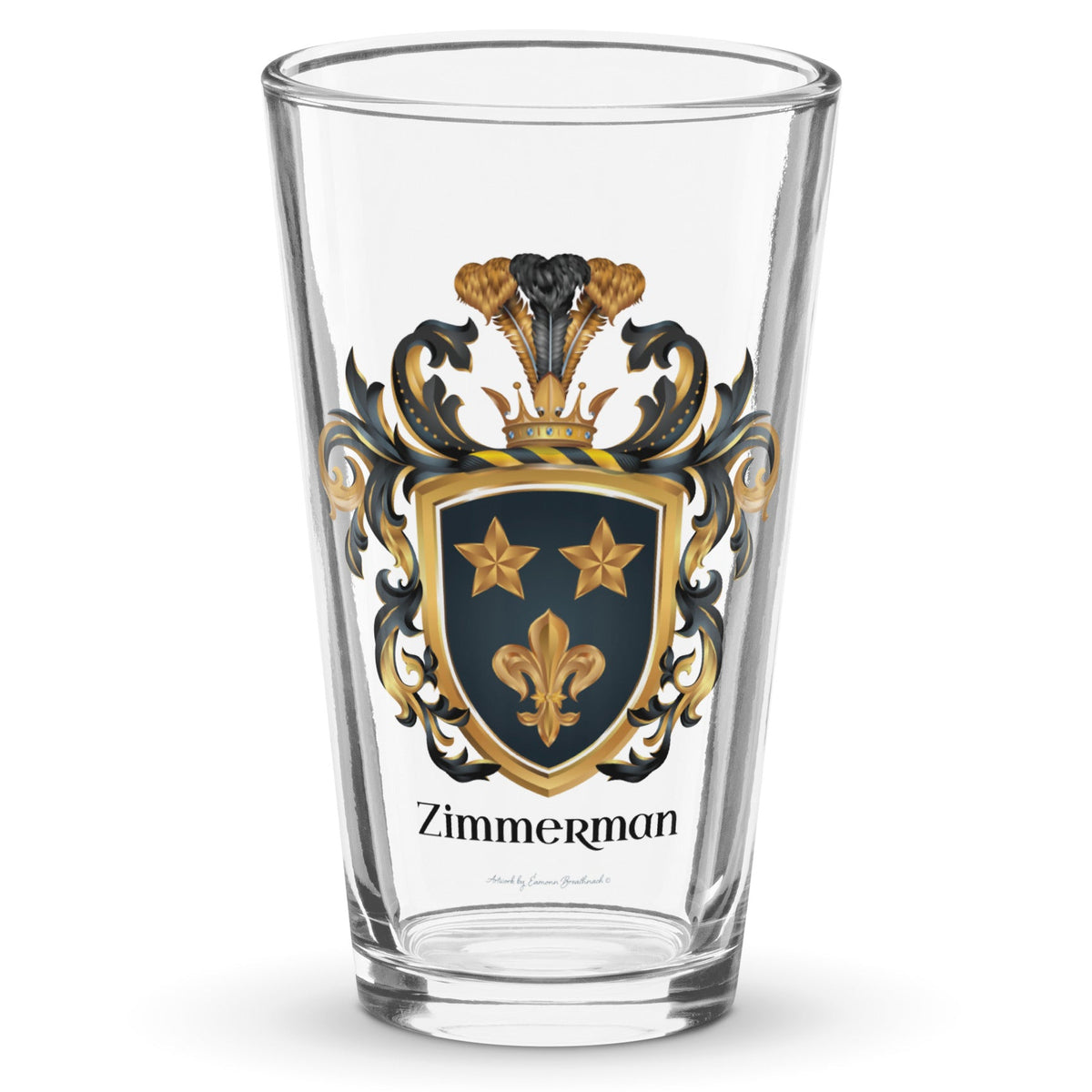 A classic pint beer glass with the  Zimmerman Family Crest printed on it showing two gold stars and a gold fleur-de-lys on a black shield