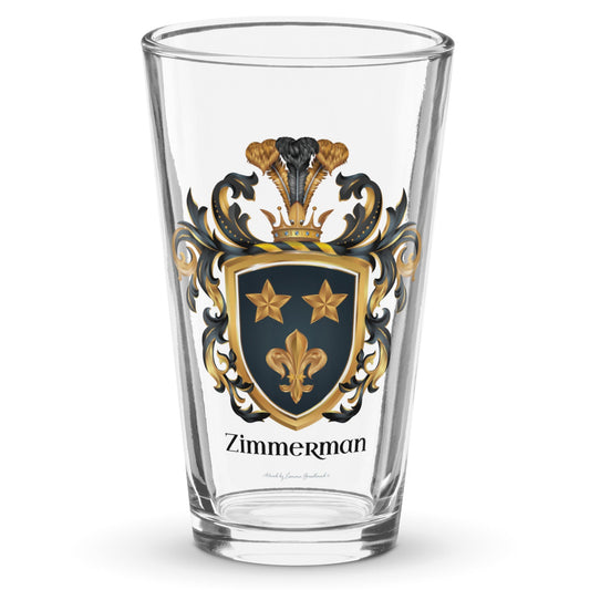 A classic pint beer glass with the  Zimmerman Family Crest printed on it showing two gold stars and a gold fleur-de-lys on a black shield