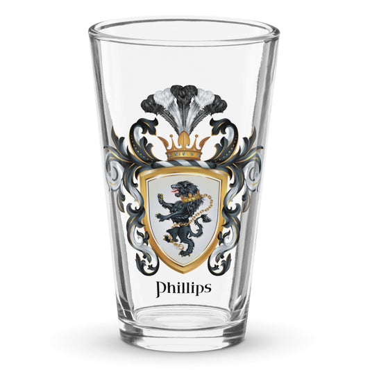 A clear classic pint beer glass on a white background, printed with the Phillips coat of arms with a black lion with a chain on a white shield.