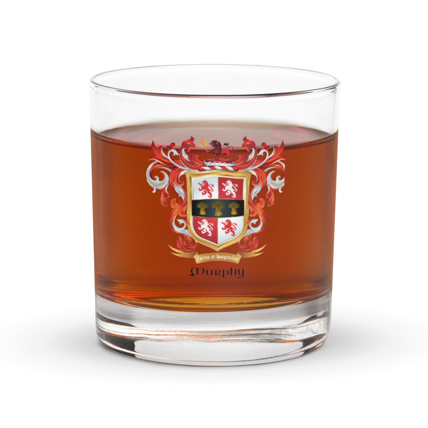 A Murphy Family Crest rocks glass with a coat of arms design almost full of  whiskey in the glass on white background 