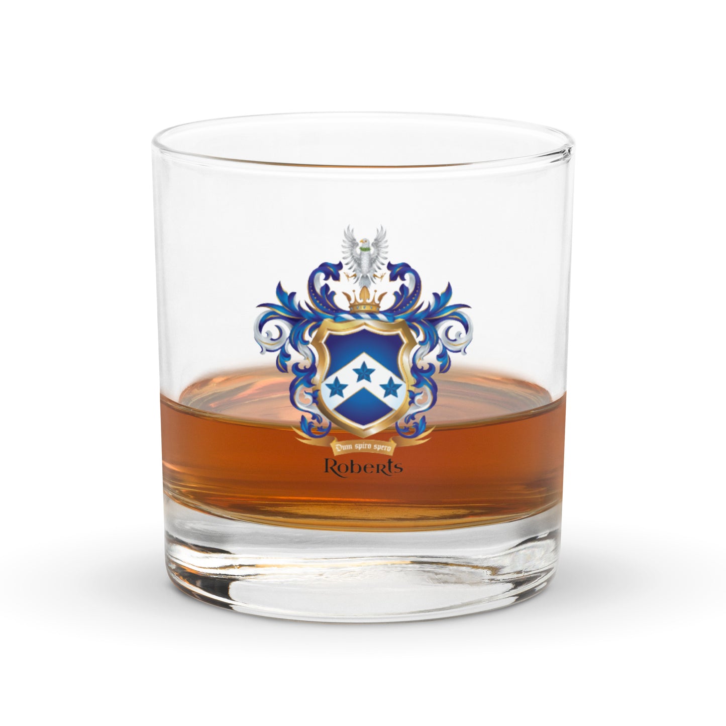Half full glass of amber liquid with a Roberts coat of arms emblem on a white background