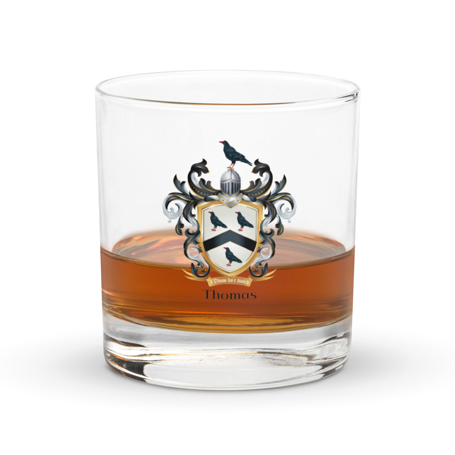 Half full g lass of whiskey with a Thomas family crest emblem on a white background