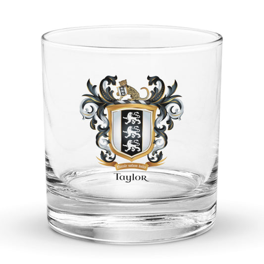 A clear rocks glass with a Taylor family crest and the name 'Taylor' in black text below the shield that has 3 white lions on a black and white shield pictured against a white background
